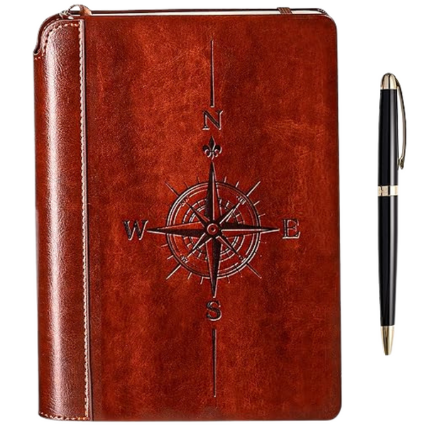 A brown vegan leatherbound journal with a compass design embossed on the cover, accompanied by a luxurious pen with gold trim.