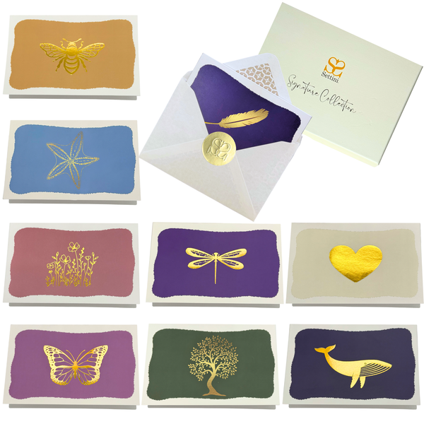 Collection of greeting cards with gold foil designs on a white background